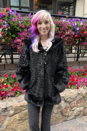 Our hooded dyed black Persian lamb jacket with dyed black mink trim is elegant and cozy. This jacket is a timeless and stylish addition to any wardrobe.
