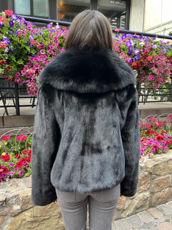Our dyed black ranch mink jacket with dyed black fox trim is warm and sophisticated. This jacket is perfect for any occasion that calls for a bit of...