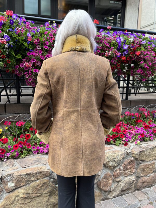 Our camel colored leather jacket with dyed rabbit fur trim combines classic style and warmth. Ideal for transitioning between seasons or adding...