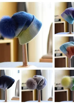 Our multi-colored wool hats with fox poms are charming and cozy. Crafted from soft wool, these hats are vibrant in color and brighten up cold days.